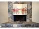 Close-up of a stone fireplace featuring unique artwork on a stone hearth and decorative stonework at 4938 Terrace Green Trce, Stone Mountain, GA 30088