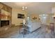 Open living area featuring a stone fireplace, hardwood floors, and seamless flow to adjacent rooms at 4938 Terrace Green Trce, Stone Mountain, GA 30088