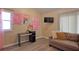Cozy living room with wood-look floors, a sofa, and decorative artwork, creating a comfortable space at 4938 Terrace Green Trce, Stone Mountain, GA 30088