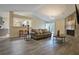 Open living room featuring hardwood floors, a stone fireplace, and open access to kitchen area at 4938 Terrace Green Trce, Stone Mountain, GA 30088