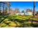 Expansive backyard featuring a well-manicured lawn, mature trees, a storage shed, and a glimpse of the home's exterior at 2120 Blaylock Dr, Marietta, GA 30062