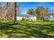 A sprawling backyard featuring mature trees and a view of the home's deck at 2120 Blaylock Dr, Marietta, GA 30062