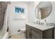 Bathroom featuring grey vanity with marble top, a shower-tub combo, and decorative floor tiles at 2120 Blaylock Dr, Marietta, GA 30062