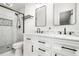 Modern bathroom with dual vanity, marble countertops, and a walk-in shower with black trim at 2120 Blaylock Dr, Marietta, GA 30062