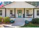 Charming front porch with a swing, colorful decor, and a bright turquoise front door at 2120 Blaylock Dr, Marietta, GA 30062