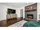 Spacious living room with modern fireplace, large tv and a stylish credenza with hardwood floors at 2120 Blaylock Dr, Marietta, GA 30062