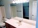 Bright bathroom featuring a vanity, sink, large mirror and tile-surround bathtub at 2657 Lenox Rd # F84, Atlanta, GA 30324