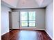 Bright bedroom features hardwood floors, a large window, and a ceiling fan at 2657 Lenox Rd # F84, Atlanta, GA 30324