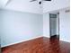 An empty bedroom with wood flooring, light blue walls, and large closet doors at 2657 Lenox Rd # F84, Atlanta, GA 30324