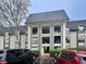 Three-story condo building with gray exterior and dark roof at 2657 Lenox Rd # F84, Atlanta, GA 30324