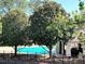 Community pool framed by lush greenery and a wrought iron fence at 2657 Lenox Rd # F84, Atlanta, GA 30324