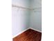 Empty walk-in closet with hardwood floors, white trim and shelving at 2657 Lenox Rd # F84, Atlanta, GA 30324