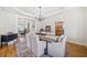 This formal dining room features hardwood floors, elegant lighting, and views into the kitchen and living area at 332 William Dr, Canton, GA 30114