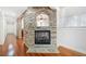 Hallway featuring a stone accent wall and hardwood floors at 332 William Dr, Canton, GA 30114