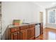 Charming wet bar area with wooden cabinets and granite countertop at 332 William Dr, Canton, GA 30114