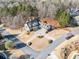 Aerial view displays a home's circular driveway, mature trees, and a well-manicured lawn at 332 William Falls Dr, Canton, GA 30114