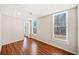 Bright bedroom featuring hardwood floors, neutral walls, and natural light from two windows with blinds at 332 William Falls Dr, Canton, GA 30114