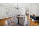 Dining room with chandelier, crown molding, hardwood floors, and access to multiple living spaces at 332 William Falls Dr, Canton, GA 30114