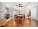 Dining room with stone fireplace, wet bar, and seating for four under trey ceiling with fan at 332 William Falls Dr, Canton, GA 30114