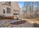 Exterior side view of home featuring a stone foundation, wood siding, and private backyard at 332 William Falls Dr, Canton, GA 30114