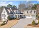 Lovely front exterior with manicured lawn, a 3-car garage, and curved driveway at 332 William Falls Dr, Canton, GA 30114