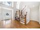 Bright foyer with hardwood floors, staircase, and entry door featuring transom window and sidelights at 332 William Falls Dr, Canton, GA 30114