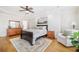 Elegant main bedroom featuring hardwood floors, a tray ceiling, and a comfortable seating area at 332 William Falls Dr, Canton, GA 30114