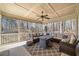 Screened porch with ceiling fan and seating arrangement and views of the backyard at 332 William Falls Dr, Canton, GA 30114