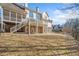 Back exterior of the home with stone and siding, and a two level porch and backyard at 332 Williamfalls Dr, Canton, GA 30114