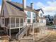 Home's rear exterior showing a screened in porch, balcony, deck, and walk out basement at 332 Williamfalls Dr, Canton, GA 30114