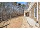 Stone walkway along the back of the house with an upper porch and lots of trees in the backyard at 332 Williamfalls Dr, Canton, GA 30114