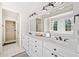 Bright bathroom showcasing dual sinks, white cabinets, and decorative lighting fixtures at 332 Williamfalls Dr, Canton, GA 30114