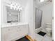 Bright bathroom with white vanity, shower-tub combo, and tile floors, providing a clean and functional space at 332 Williamfalls Dr, Canton, GA 30114