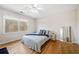 Cozy bedroom features hardwood floors, a ceiling fan, and a large window that provides ample natural light at 332 Williamfalls Dr, Canton, GA 30114