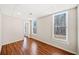Bright bedroom features hardwood floors, fresh paint, and natural light from the windows at 332 Williamfalls Dr, Canton, GA 30114