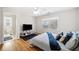 Bright bedroom with hardwood floors, a ceiling fan, and a view of the exterior. Bathroom located off bedroom at 332 Williamfalls Dr, Canton, GA 30114