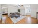 Spacious bonus room with hardwood floors and comfortable seating, next to another bedroom at 332 Williamfalls Dr, Canton, GA 30114