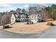 Spacious home on a large lot with a circular driveway and mature trees at 332 Williamfalls Dr, Canton, GA 30114