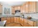 Bright kitchen with granite countertops, wood cabinets and tile backsplash, and view to backyard at 332 Williamfalls Dr, Canton, GA 30114