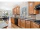 View of the kitchen with stainless steel sink, granite countertops, wood cabinets and view of dining area at 332 Williamfalls Dr, Canton, GA 30114