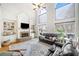 Grand living room with a stone fireplace, built-in shelves, and soaring ceilings at 332 Williamfalls Dr, Canton, GA 30114