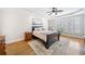 Serene main bedroom with tray ceiling, hardwood floors, plantation shutters, and stylish decor at 332 Williamfalls Dr, Canton, GA 30114
