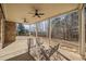 Covered patio with metal table and chairs with ceiling fans and wooded view at 332 Williamfalls Dr, Canton, GA 30114