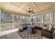 Inviting screened porch with comfortable seating, a ceiling fan, and serene views of the surrounding woods at 332 Williamfalls Dr, Canton, GA 30114