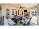 Cozy screened porch with stone fireplace, ceiling fan, and comfortable seating area at 332 Williamfalls Dr, Canton, GA 30114