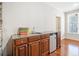 Home features wet bar with wood cabinets, granite countertop, stainless refrigerator, and sink at 332 Williamfalls Dr, Canton, GA 30114