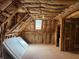 An unfinished attic space featuring exposed wooden beams and a window at 4508 Bankside Court, Marietta, GA 30066