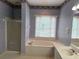 Well lit bathroom featuring a soaking tub and vanity at 4508 Bankside Court, Marietta, GA 30066