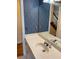 Bathroom featuring floral wallpaper, a large mirror, and a white countertop sink at 4508 Bankside Court, Marietta, GA 30066