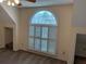 Bedroom featuring a arched window with white shutters, gray carpeting, and two entryways at 4508 Bankside Court, Marietta, GA 30066